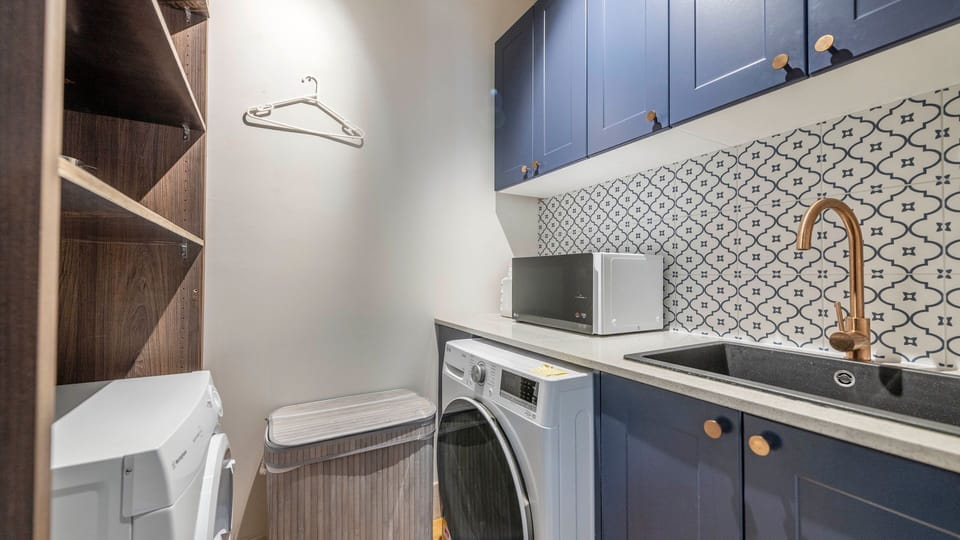 Laundry nook with washer and dryer—perfect for longer stays.