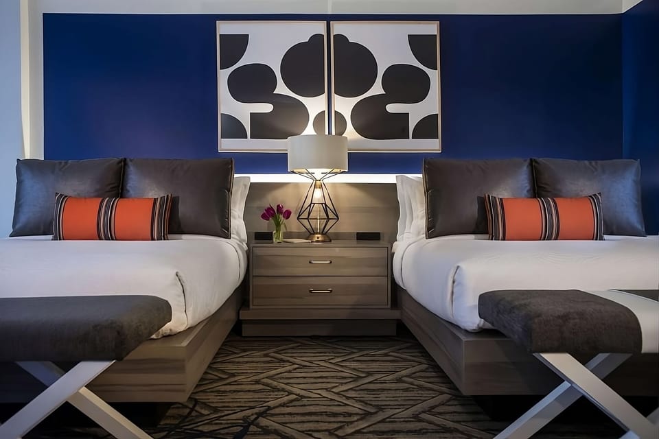 Drift off in plush beds with glowing bedside ambiance.