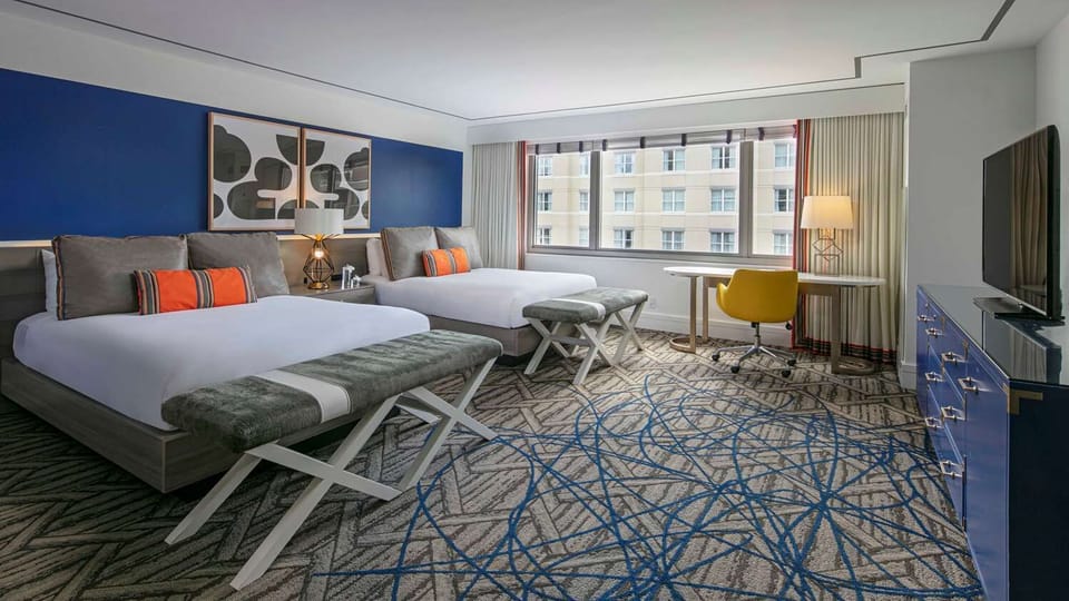 Stretch out in a spacious double-queen room with sunny workspace.