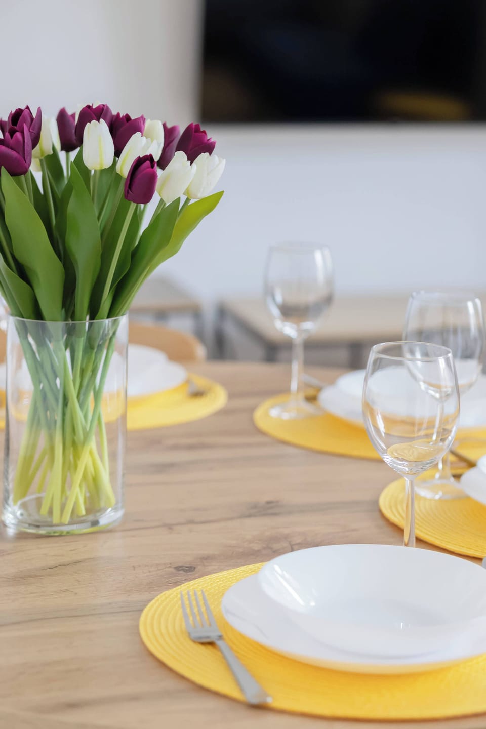 The elegant table setup with flowers creates a pleasant atmosphere. It's a perfect spot for a shared meal.