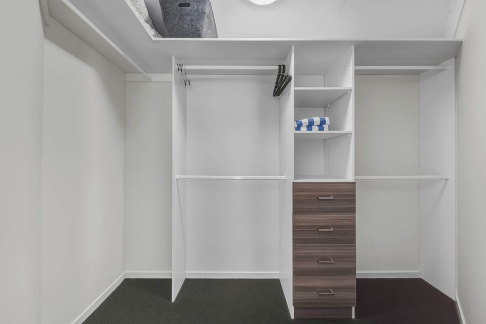 A spacious walk-in wardrobe with ample storage for a comfortable, clutter-free stay.