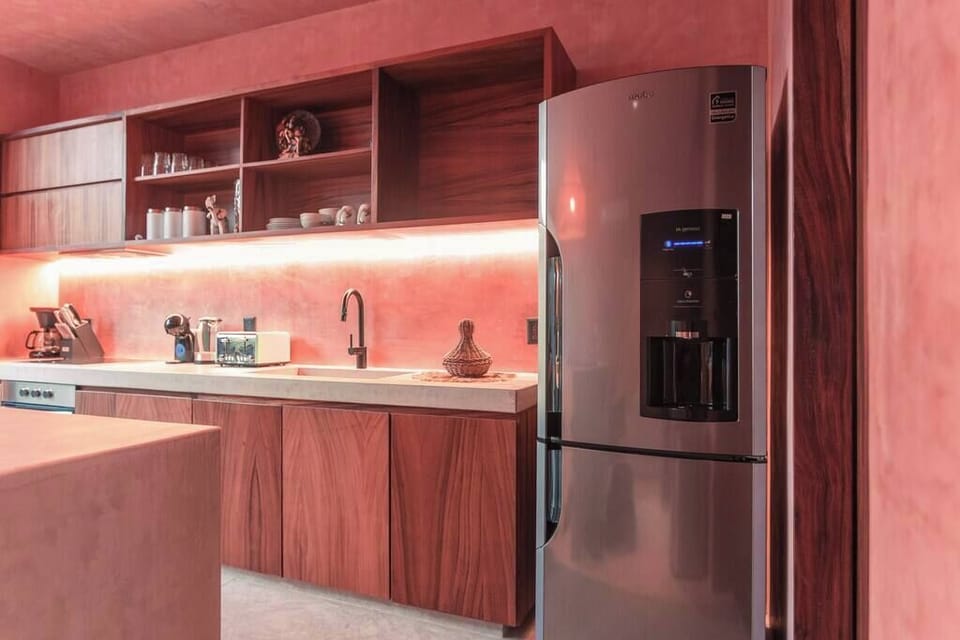The kitchen features a fridge, microwave, toaster, coffee pot, & all utensils, cookware, dishware, & glassware needed during your stay.