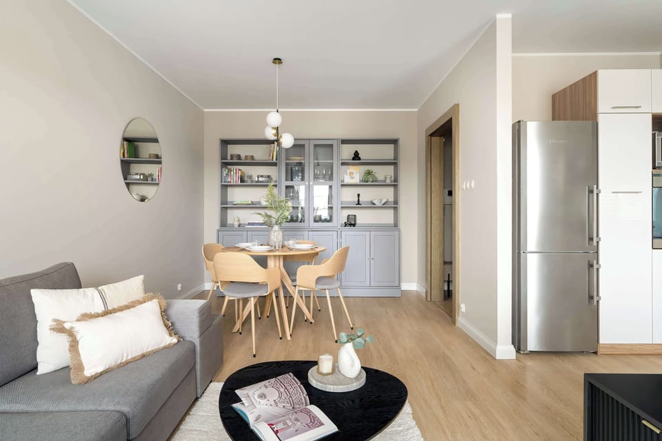 Open living area with soft colours, rounded furniture, and a well-arranged layout.