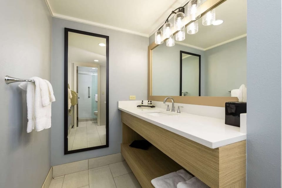 Bathroom with wide vanity, mirror, and walk-in shower