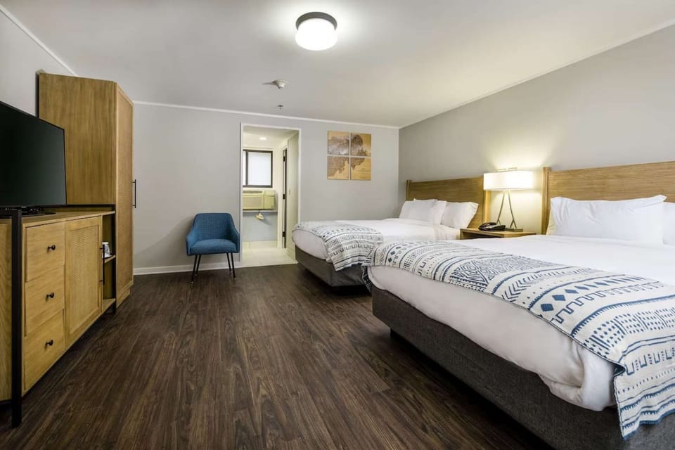 Two-bed guest room with wood floors and comfy layout