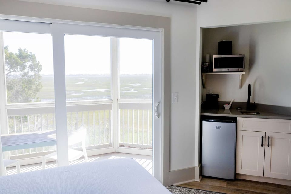 Balcony with marsh view and small kitchen area with fridge