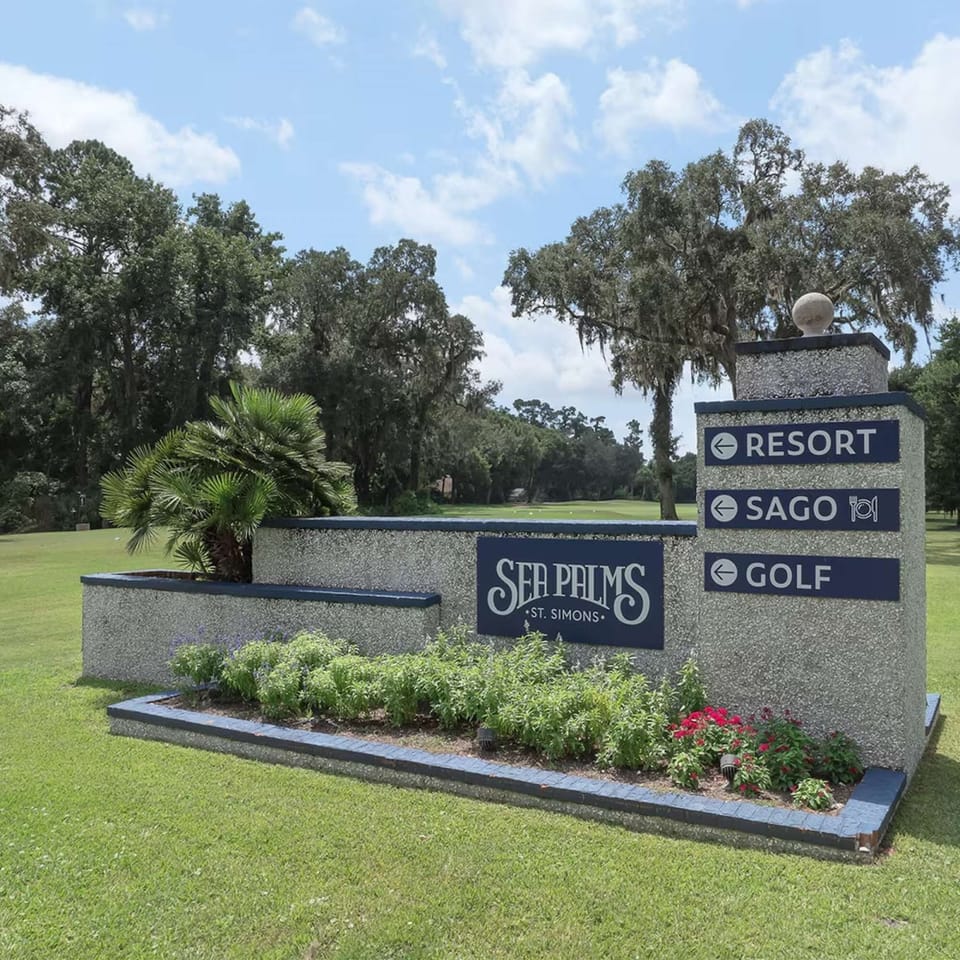 Entrance sign with directions to resort, Sago dining, and golf