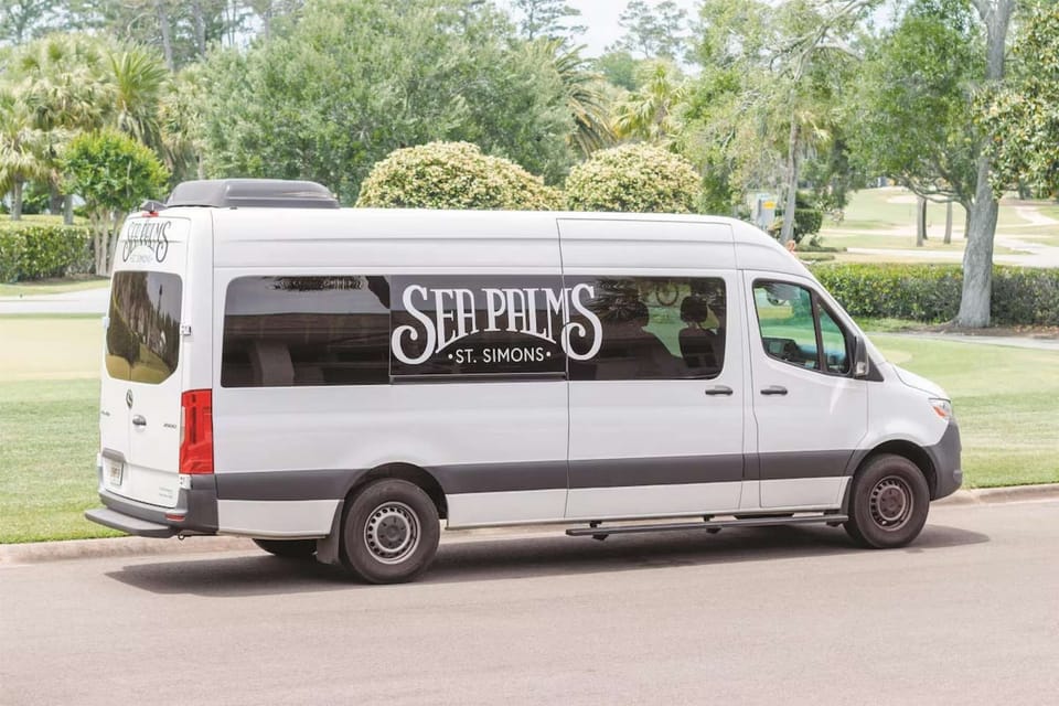 White Sea Palms shuttle van parked by the green golf course road