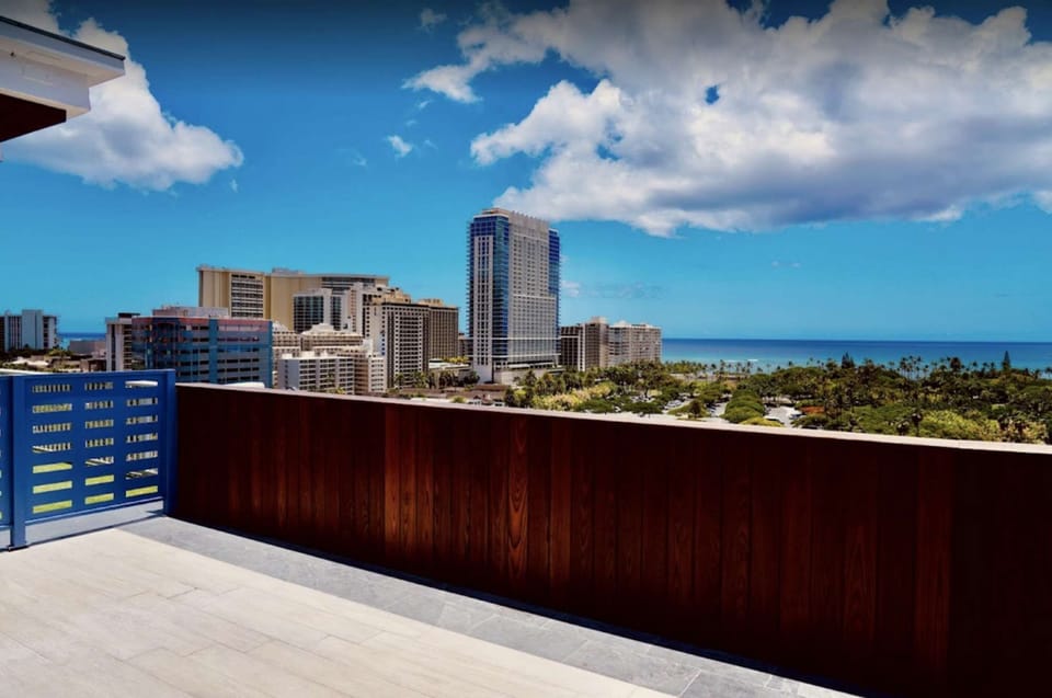City and ocean views from a wide outdoor terrace