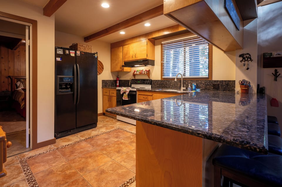 Kitchen with large countertop and barstools