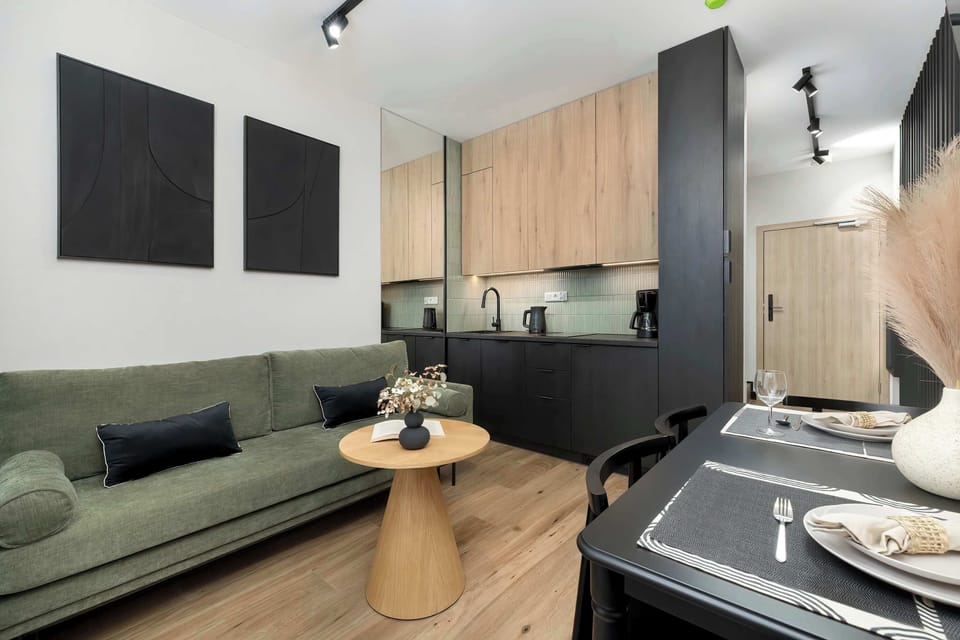 The elegant living room featuring a double sofa bed, perfect for relaxing or sleeping.