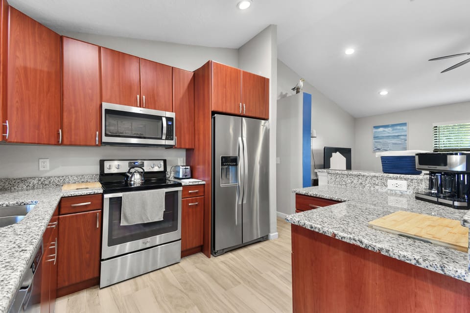 Kitchen with granite countertops and stainless fridge