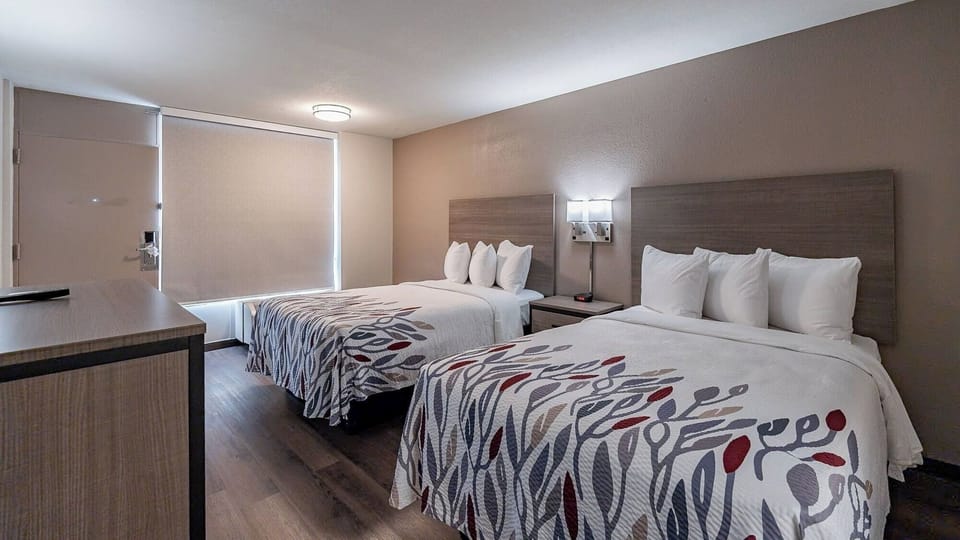 Wake up refreshed in a sunny room with two beds.
