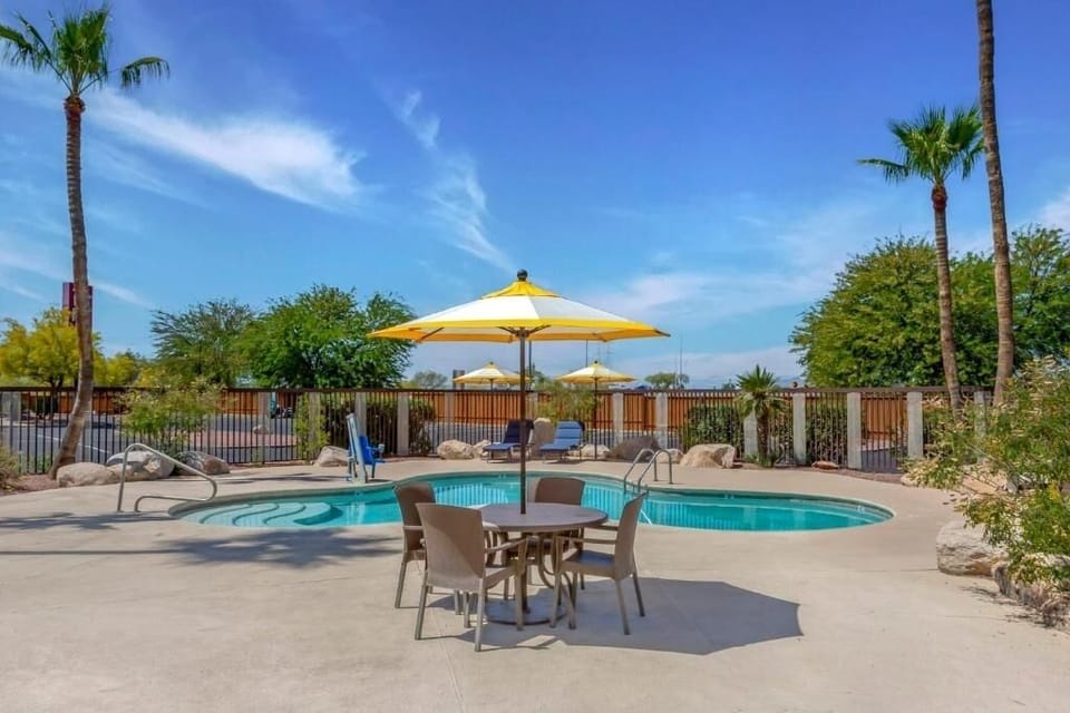 Gather poolside under umbrellas for breezy afternoon lounging.