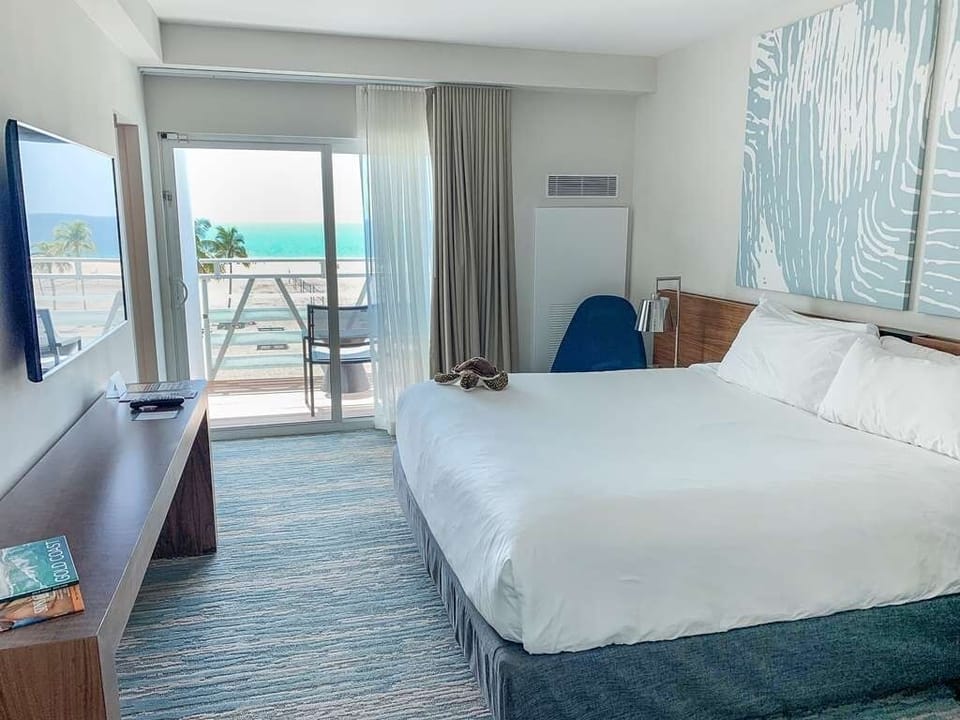Wake up to sea breezes with balcony steps from bed.