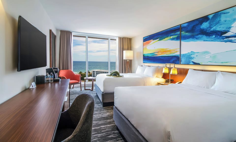 Bask in panoramic ocean views from a serene, modern bedroom.