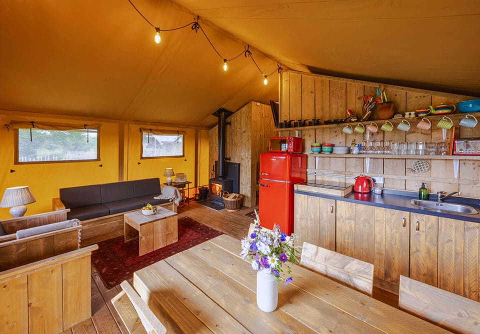 Spacious open-plan kitchen, dining and sitting area with a log burner