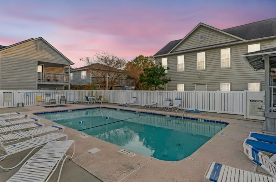 Take a cool dip in the sparkling pool after a fun day at the beach.
