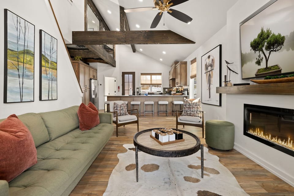 The living room has seating, an electric fireplace, and access to the patio!