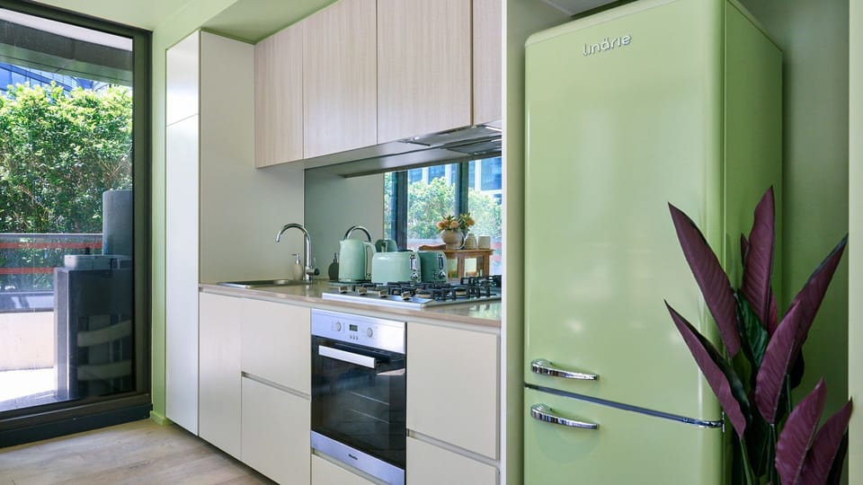 Fully equipped kitchen featuring modern appliances and ample bench space.