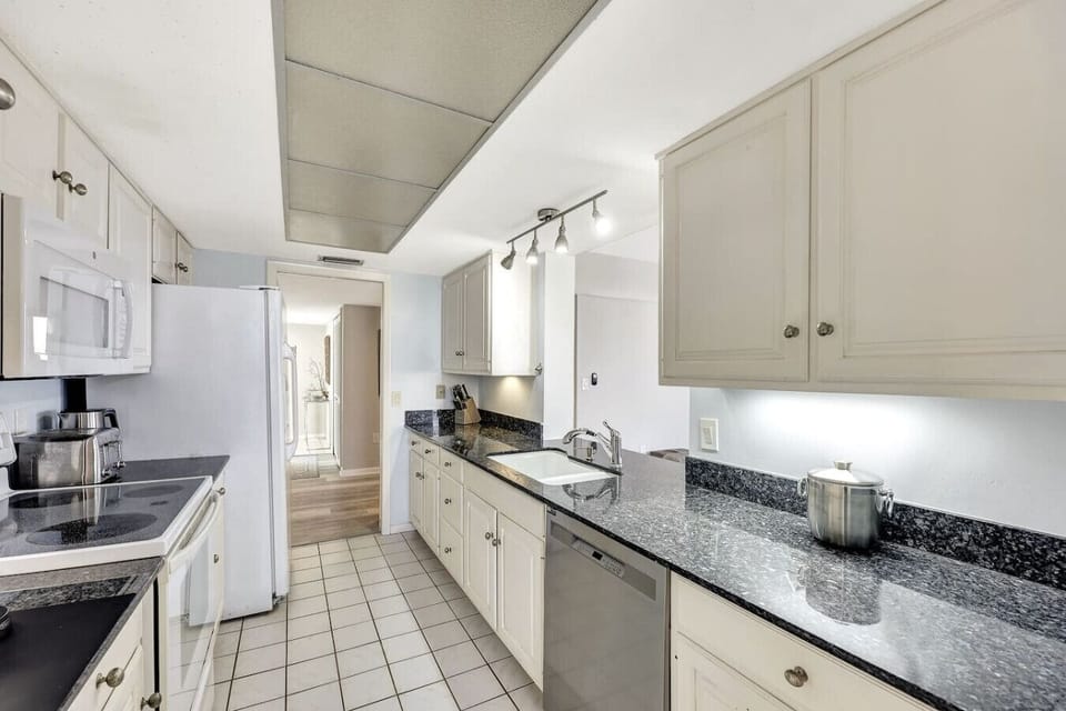 The kitchen leads to both the front door and the living area.