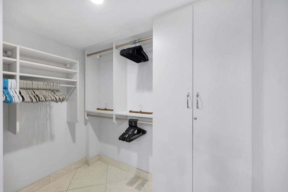 The walk in closet is spacious and well lit.