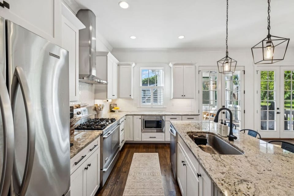 Fully-equipped, modern kitchen with stainless steel appliances,  stone countertops, a 5 burner gas stove with double ovens and a walk-in pantry! Seating for 4 at the kitchen island.