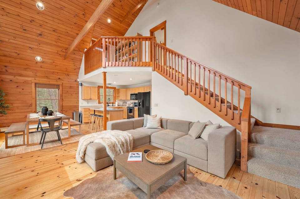 [First Floor, Living Room] This is how we envision the quintessential cabin retreat. Warm wood, natural light, cathedral ceilings, and neutral colors.