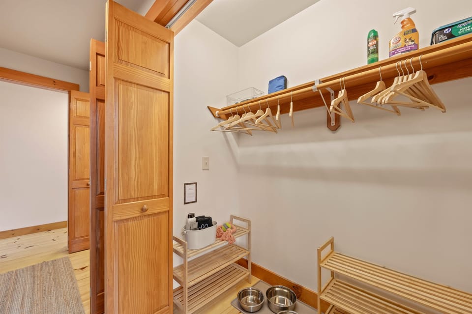 [First Floor, Entryway - Closet] In addition to space for coats and shoes, this closet contains water and food bowls for your furry family friends.