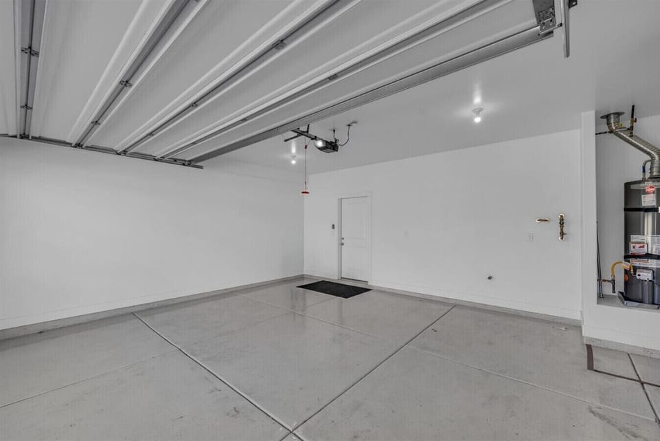 Spacious private garage with room for vehicles and gear.