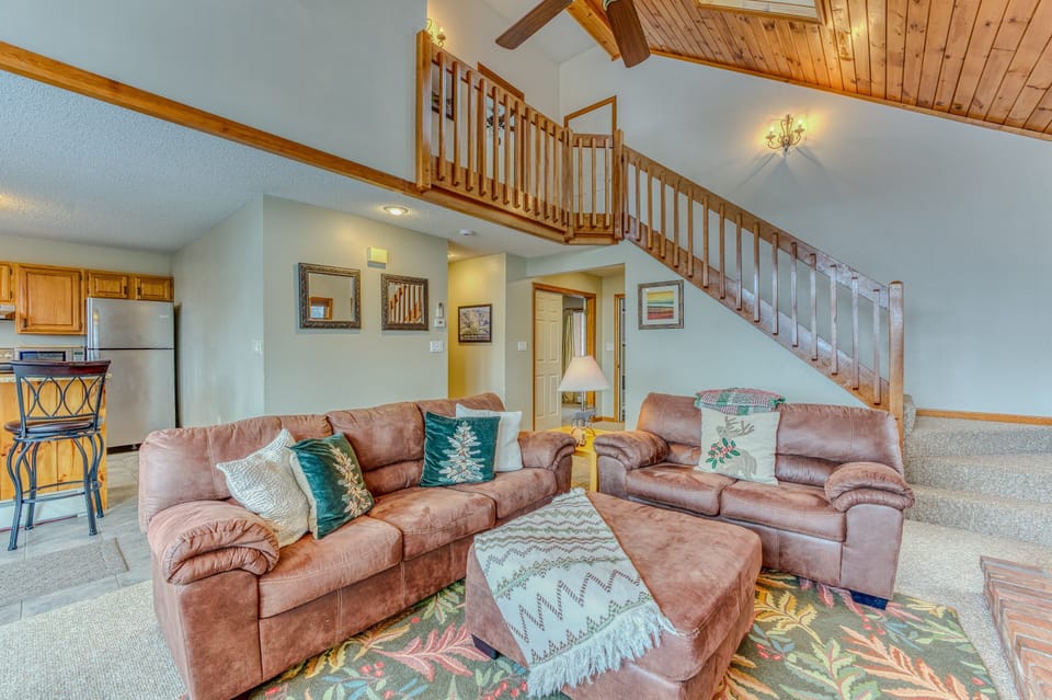 Main Level Living area with Gas Fireplace, TV and adjacent to Kitchen and Dining Areas