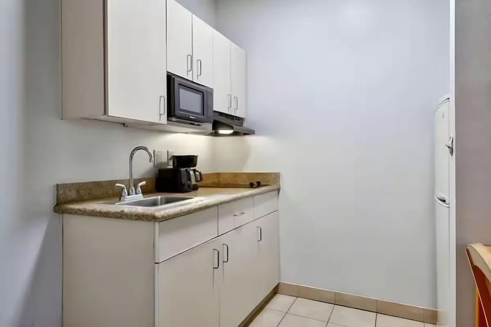 Prepare quick snacks with sink, microwave, and ample cabinets.