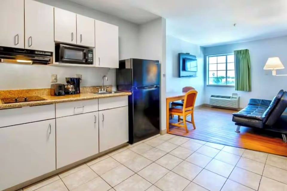 Settle in with a full kitchenette and cozy seating.
