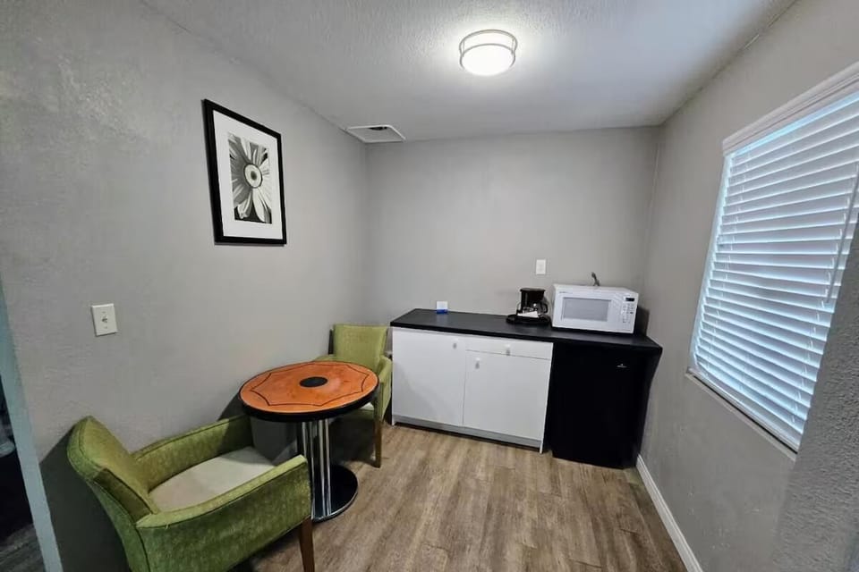 Sip morning coffee at a cozy table by the kitchenette.