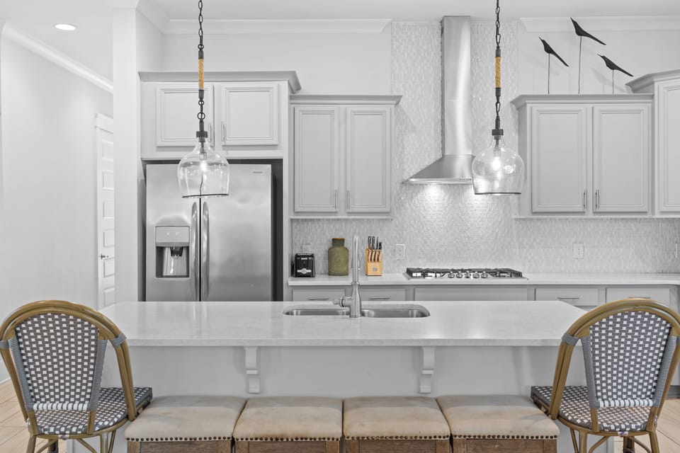 Stylish kitchen detail: hood, stove, and subway tile backsplash.