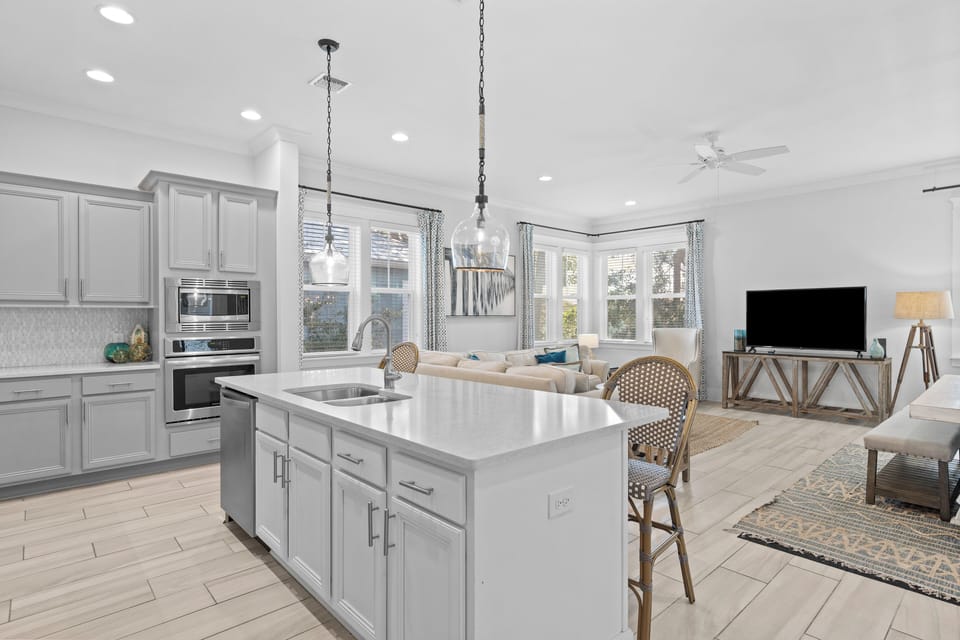 Gourmet kitchen with large center island and stainless steel appliances.