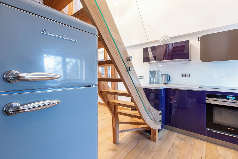 Modern Kitchen with Retro Fridge and Wooden Stairs