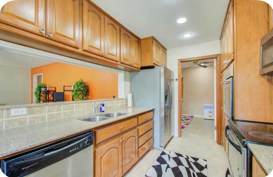 Discover ample space for culinary creations on our spacious countertops in the kitchen, complemented by a convenient half-wall counter.