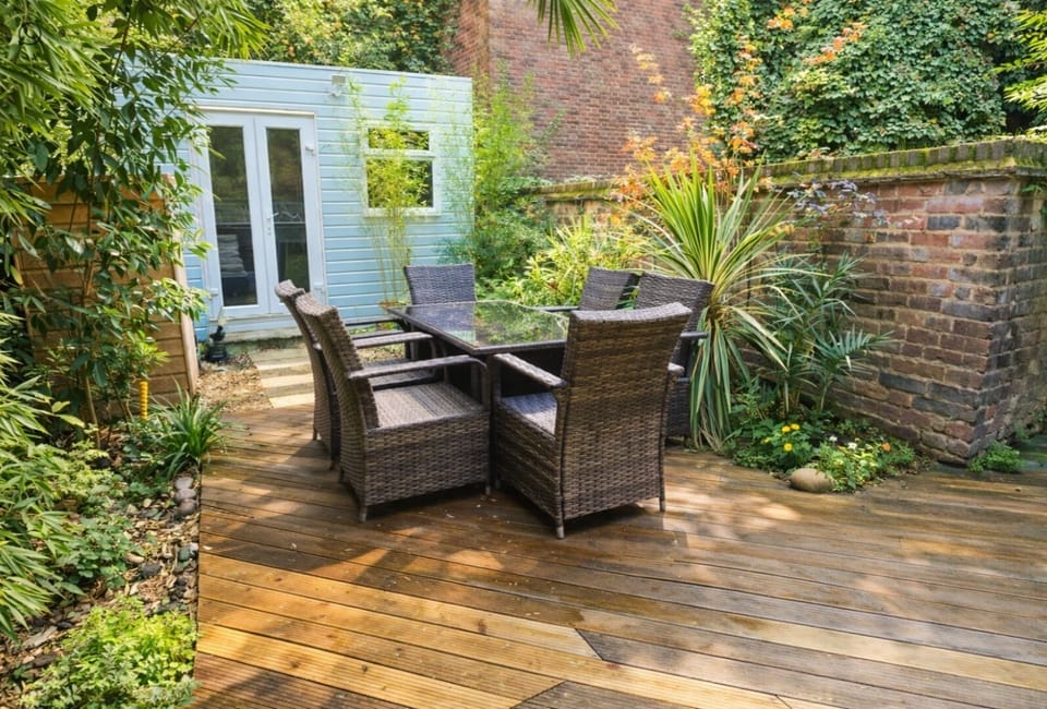 Upper decking with outdoor dining for 6 people and garden office studio.