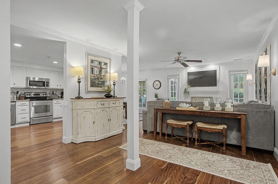 Relax in your beautifully appointed open-plan living space with rich hardwood floors, comfortable seating, and a fully equipped kitchen.