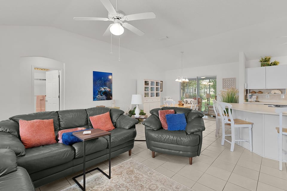 Unwind in your spacious living area with comfortable leather seating and an open-concept layout that flows seamlessly into the kitchen.