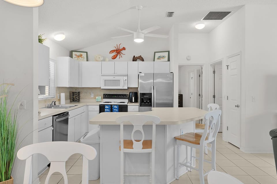 Your bright, airy kitchen features modern appliances and a breakfast bar perfect for morning coffee and casual meals.