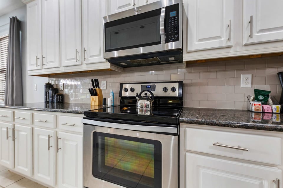 Fully equipped kitchen with stainless steel appliances.