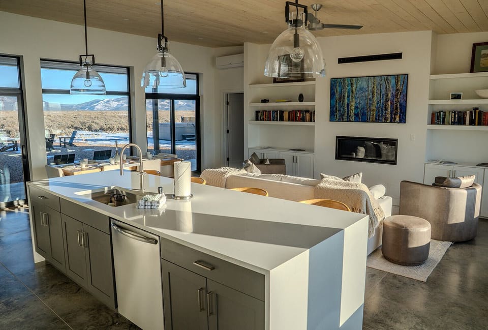 You'll love cooking in this stunning modern kitchen while enjoying breathtaking mountain views through floor-to-ceiling windows.