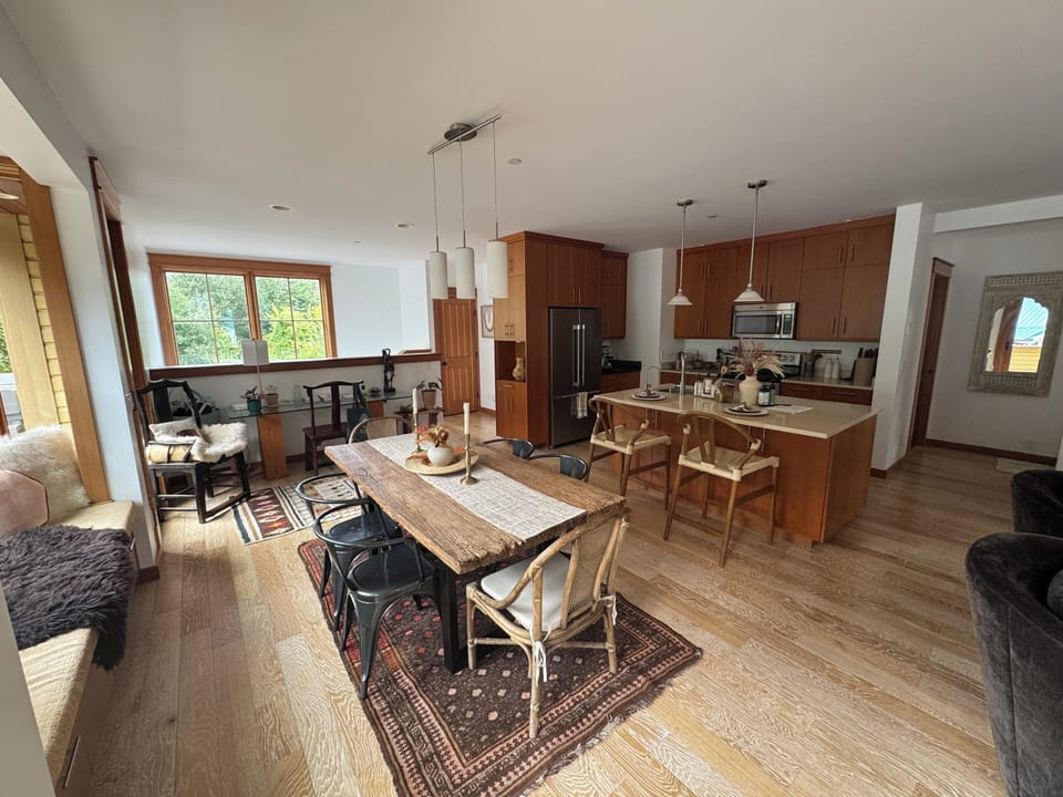 Dining area and full kitchen with kitchen island.