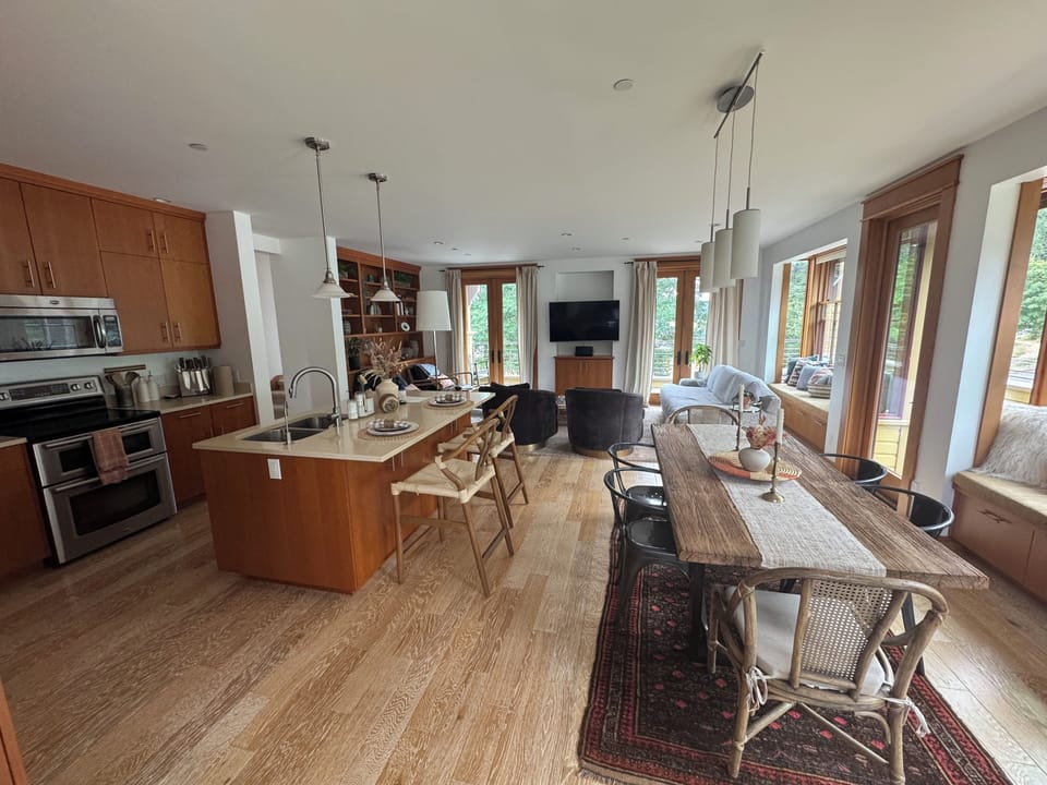 Full kitchen and dining area. Living room and doors out to the wrap-around deck