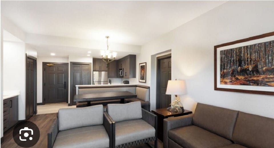 Main living room with pull-out couch and full kitchen with dining area.