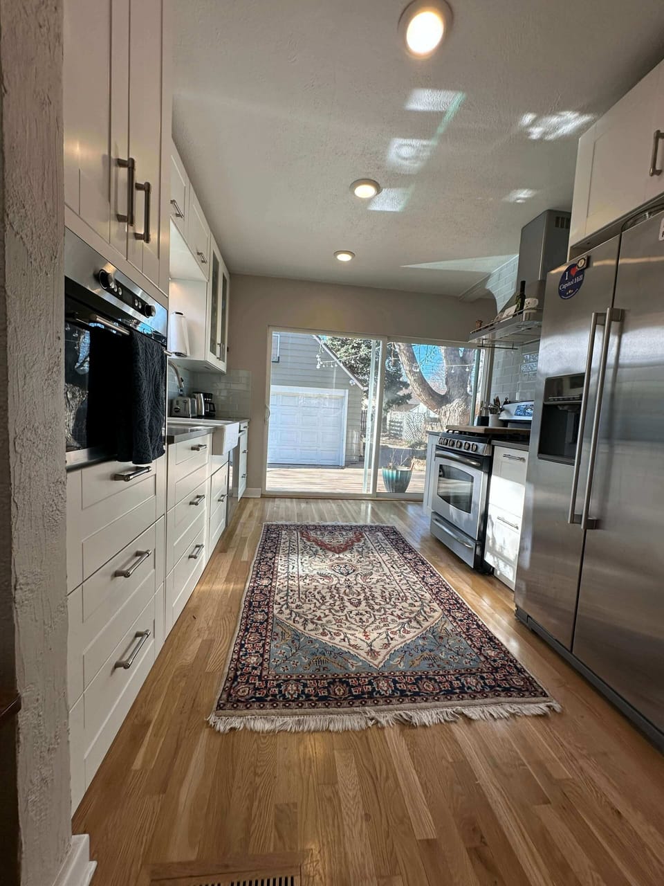 DR view into Kitchen and out back sliding glass door