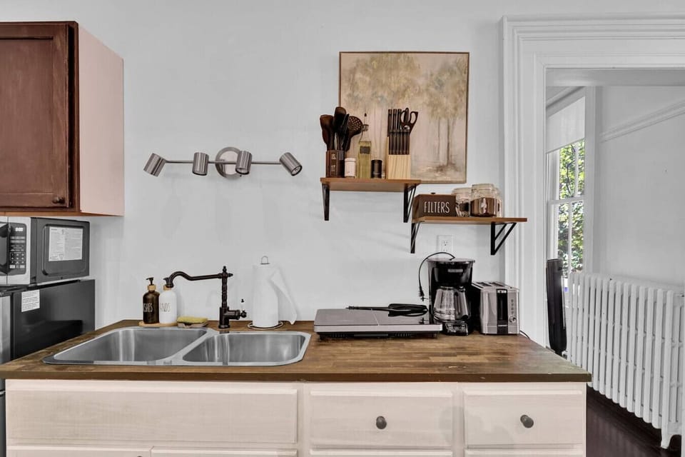 Enjoy a thoughtfully designed kitchenette that blends rustic textures with modern convenience. This efficient space is fully equipped to handle your morning coffee ritual or a quick evening meal during your stay.