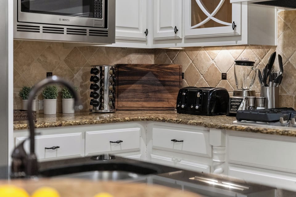 Spices, cutting board, toaster in kitchen